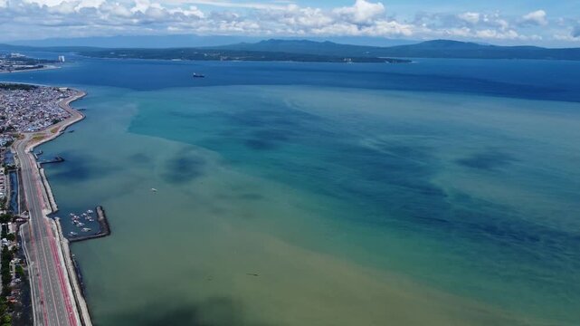 Drone aerial footage of Davao, Philippines featuring dense urban housing, residential neighborhoods, city infrastructure, bridge and compact urban development captured from above.