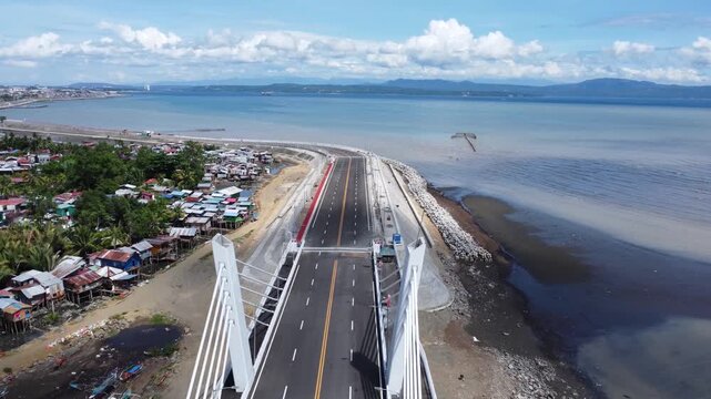 Drone aerial footage of Davao, Philippines featuring dense urban housing, residential neighborhoods, city infrastructure, bridge and compact urban development captured from above.