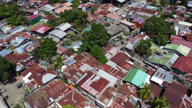 Drone aerial footage of Davao, Philippines featuring dense urban housing, residential neighborhoods, city infrastructure, bridge and compact urban development captured from above.