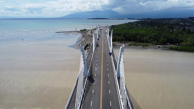 Drone aerial footage of Davao, Philippines featuring dense urban housing, residential neighborhoods, city infrastructure, bridge and compact urban development captured from above.