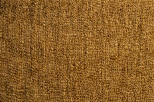 Closeup texture of yellow woven textile material. Perfect backdrop for minimalist designs, fashion moodboards, home decor templates or organic product photography background