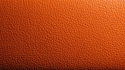 Fototapeta premium Close-up of vibrant orange grained leather texture background