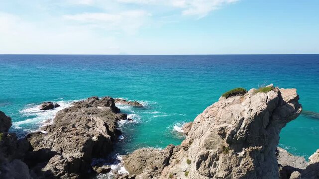 Aerial view of the rocky coastline in Zambrone on the Costa degli Dei, Calabria, Italy, featuring crystal clear turquoise waters of the Tyrrhenian Sea and dramatic Mediterranean cliffs 