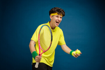 Cheerful Young Tennis Player Celebrating Victory with Racket and Balls © st.kolesnikov
