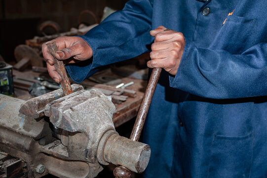 Worker using a large metal vice