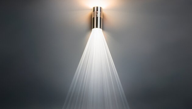 a bright beam of light from a flashlight shines on a gray background