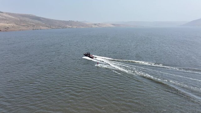 Beginner Water Skier Losing Balance and Falling into Water, Aerial View