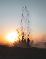 Fototapeta premium Sunset with Dramatic Water Eruption Scene.