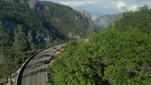 El Portal Rd - road to Yosemite Valley showcasing dramatic granite cliffs, lush forests, and winding river under natural daylight in California&rsquo;s Sierra Nevada.	
