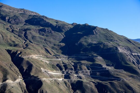 Drafting a concise SEO-friendly description for the scene.
Winding mountain roads carve through rugged Himalayan terrain in Lhozhag County, Lhoka Shannan, Tibet, showcasing dramatic highland landscape