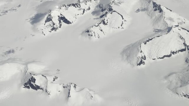 An icefield basin fills a high glacial bowl ringed by rocky nunataks