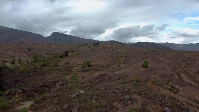 Horizontal_Aerial drone view desert area mountain stone and rock area cloudy day Villa de leyva, Boyaca, Colombia