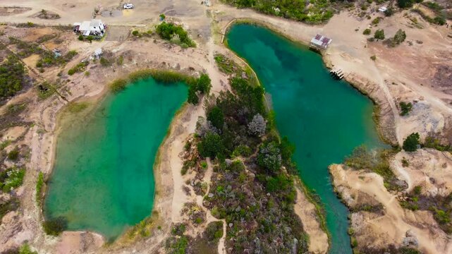 Hotizontal_Aerial drone view of the blue lakes surrounded by trees and arid deserts in Villa De Leyva, Boyaca ,Colombia 4k