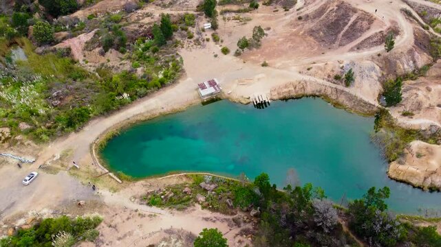 Hotizontal_Aerial drone view of the blue lakes surrounded by trees and arid deserts in Villa De Leyva, Boyaca ,Colombia 4k