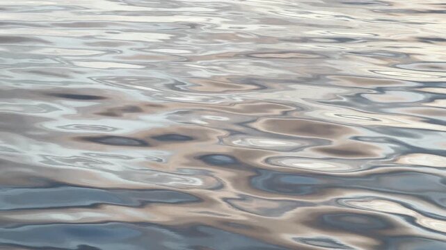 Glassy Pewter and Tan Reflections Swirling Across Slack Calm Water