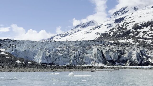 Spring sun lights the crevassed blue face of Lamplugh Glacier