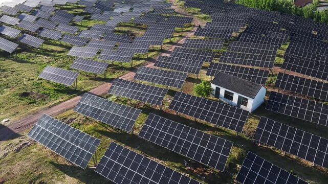 Aerial view of a large-scale solar photovoltaic power station with orderly panel arrays