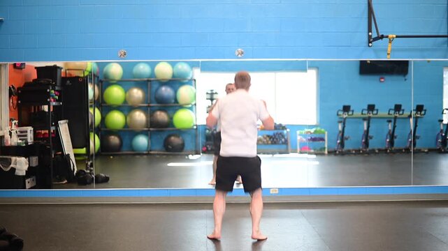 Man working out in the gym open space big mirror bright exposure