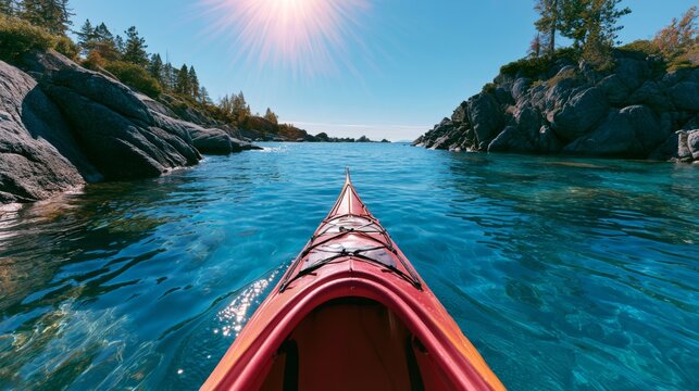 Cinematic kayaking experience on bright blue water during summer with dramatic landscape in the background