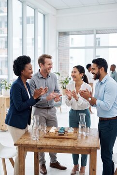 Diverse Business Team Celebrating Success with Cupcakes and Applause in Modern Office