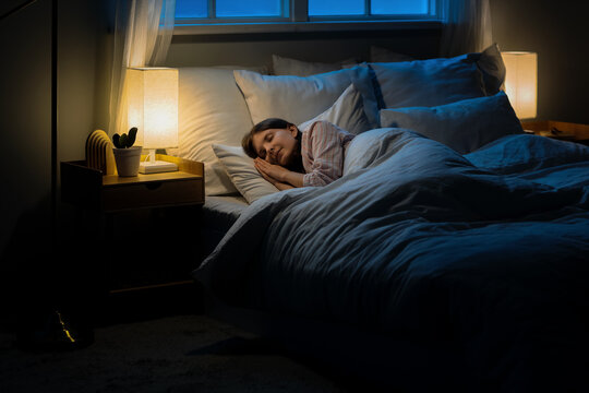 Woman sleeping peacefully in bed at night