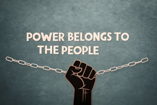 Fist Silhouette Breaking Chain with 'Power Belongs to the People' Message