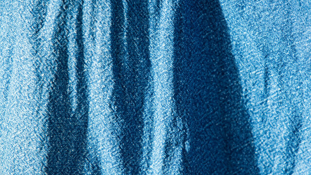 Macro shot of natural indigo dye fabric texture background.  A beautiful macro close-up showcasing the detailed texture of a traditional indigo-dyed cotton fabric.