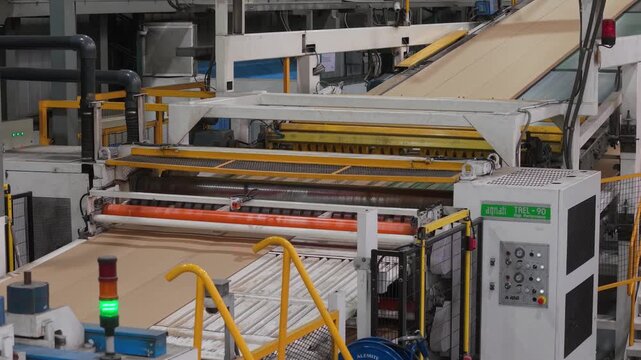 Cardboard machine operating in industrial factory. Assembly line, production, technology, machinery, conveyor belt, industrial automation