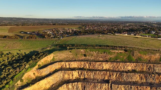 Marino, Adelaide, South Australia &ndash; 4K aerial drone footage of Linwood Quarry, limestone extraction, hard rock aggregates, terraced quarry walls, mining operation between Seacliff Park, Hallett Cove