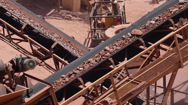 Intersecting Conveyor Belts Transporting Crushed Rock Through a Quarry Processing Plant