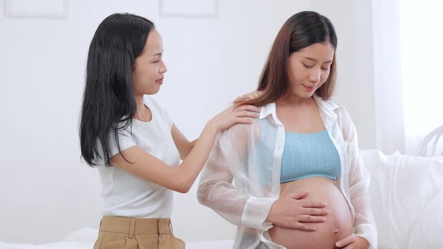 Close-up of a pregnant mother receiving a relaxing shoulder massage from her supportive friend or professional caregiver to alleviate prenatal body discomfort.