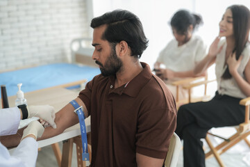 Fototapeta premium Doctor wearing a face mask examines and consults a patient during a medical checkup in a bright modern clinic.