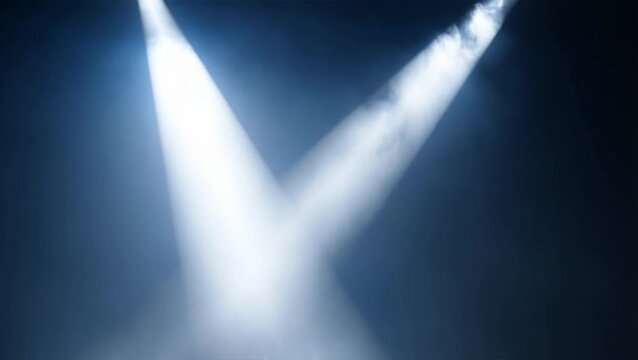 The stage is set with a spotlight shining through the fog.