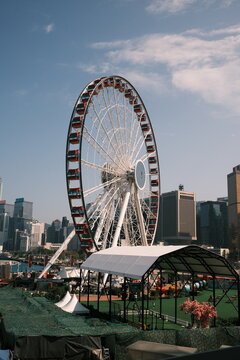 View of the Hong Kong Observation Wheel set against the modern urban skyline and skyscrapers of Hong Kong, Hong Kong.