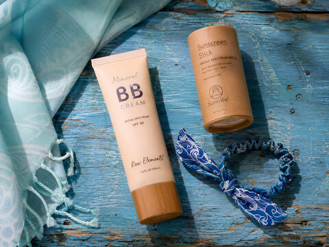 Tropical Hair Oil and Frangipani on Sun-Aged Blue Plank