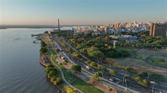 Porto Alegre city skyline with riverfront park and truck-right movement at sunset