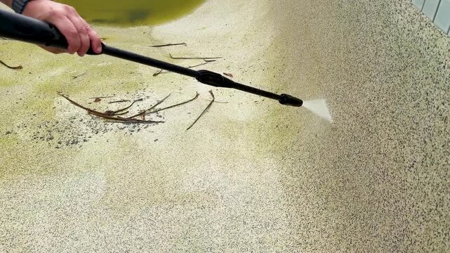 High Pressure Water Jet Cleaning Algae From Concrete Swimming Pool