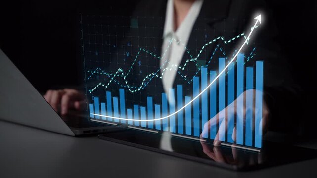 A business professional examines data trends on a laptop, showcasing an engaging graph interface with increasing metrics, symbolizing growth and success in a modern workspace. Copula