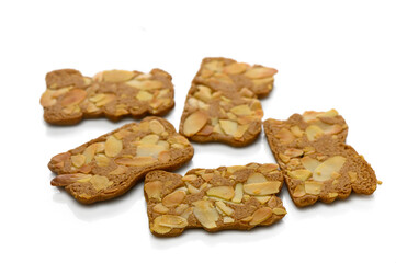 Fototapeta premium Deliciously crunchy gingerbread cookies topped with sliced almonds for a sweet treat