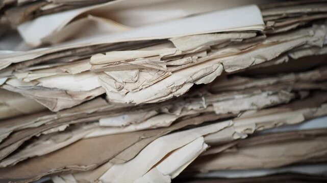 Old papers stacked in a messy pile in an office setting