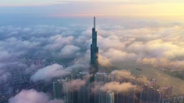 Aerial drone view of Landmark 81 rising above clouds at sunrise in Ho Chi Minh City Vietnam