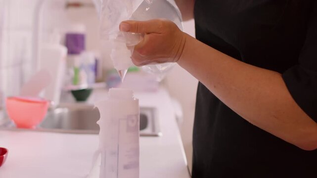 Pouring beauty liquid. Therapy treatment. Unrecognizable professional female beautician using cleansing product in bottle for spa skin care.