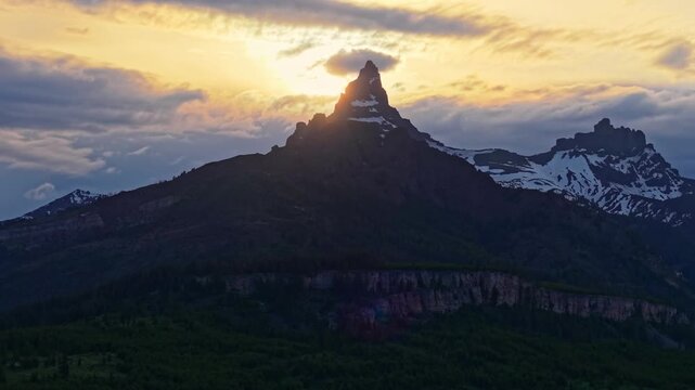 Scenic aerial view of the Beartooth Mountains illuminated by a dramatic sunset sky