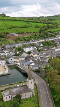 Vertical social ratio aerial video of Glenarm Town, on the Causeway Coastal Route in County Antrim, Northern Ireland in the UK on a sunny day. Produced in 3840x2160 and with Rec709 color.