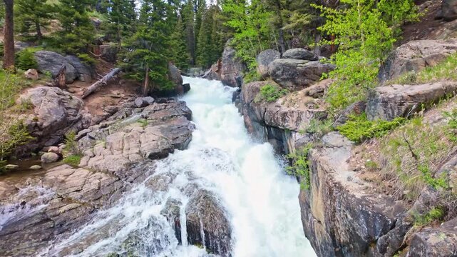 Lake Creek mountain river flows harshly through rocky terrain along the Beartooth Highway in Wyoming