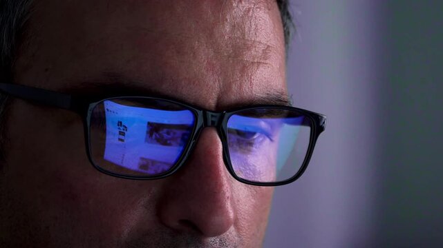 Pc Screen Reflection on Glasses, Person Scrolling in Social Media , Close up Shot