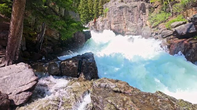 Lake Creek mountain river flows harshly through rocky terrain along the Beartooth Highway in Wyoming