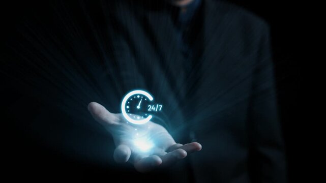 A hand holds a glowing digital clock icon with 24 hour written on it, symbolizing constant availability and modern communication tools in a dynamic business setting. Qubit