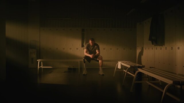 Man with Leg Prosthesis Sits on Bench, Looking Thoughtfully out Window, Exhaling Slowly, and Stretching Neck. Strong, Determined Gaze Directly into Camera, Symbolizing Resilience, Mental Readiness.