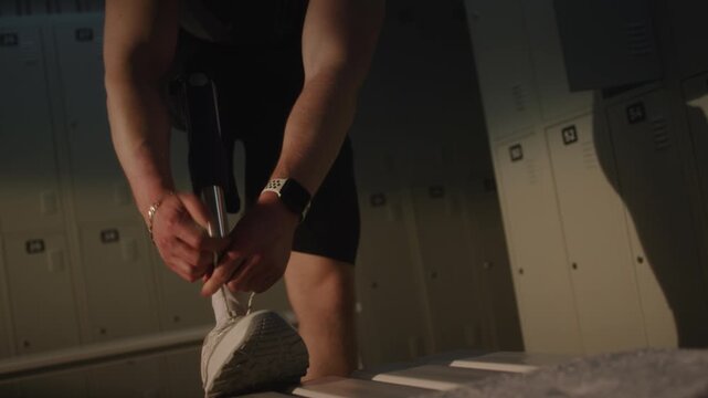 Close Up of Modern Mechanical Leg Prosthesis as Male Athlete Carefully Ties Sneakers. Integration of Advanced Medical Technology Into Active Lifestyle. Future of Mobility and Inclusive Fitness.